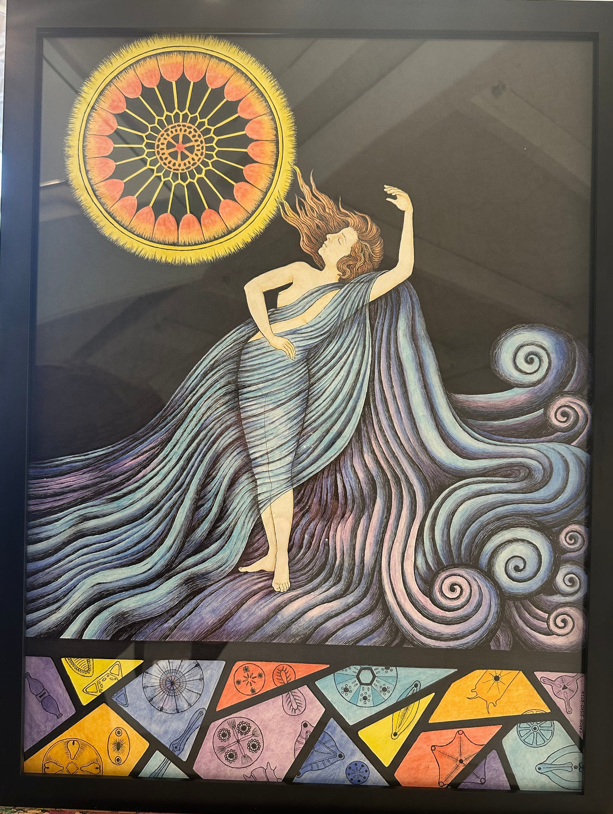 Framed artwork of a woman with flowing hair and colorful geometric patterns.